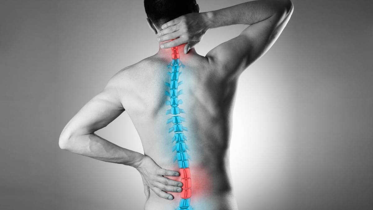 A man suffering from scoliosis back pain