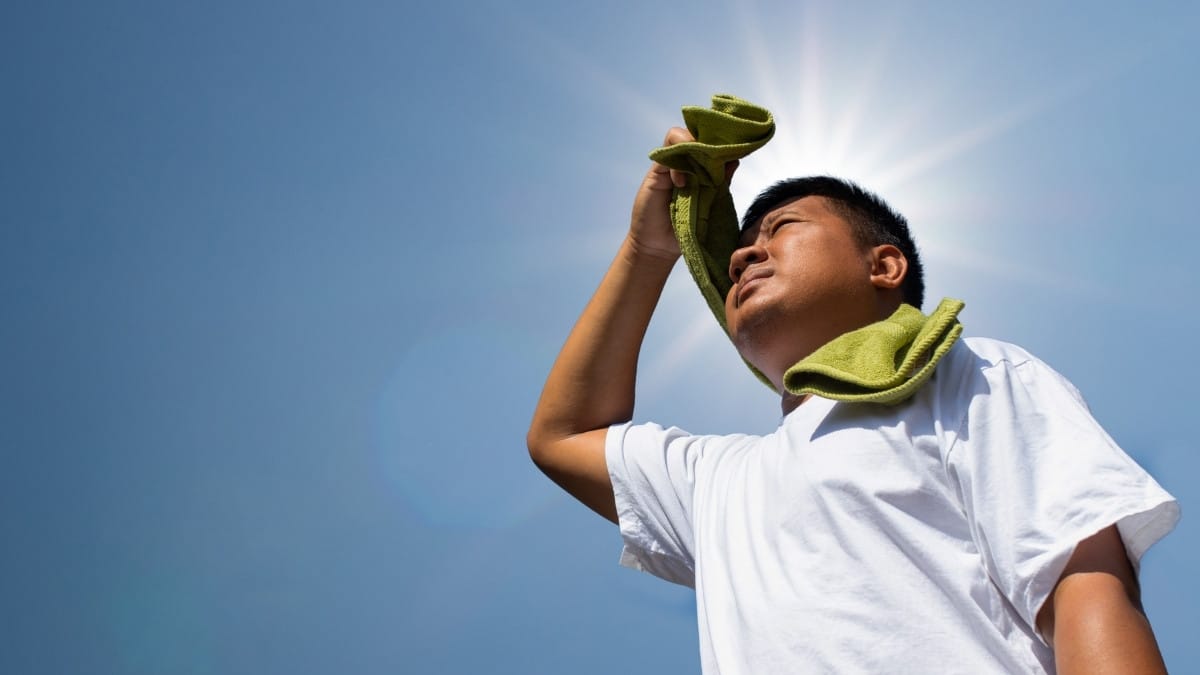 Man covering his head from heat stroke