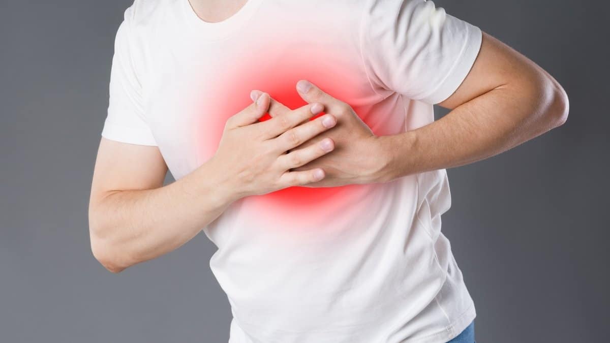 A man holding chest, encountering heart attack