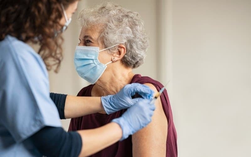 Woman getting COVID-19 vaccine.