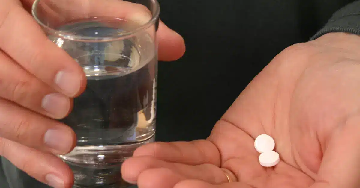 man taking two pills