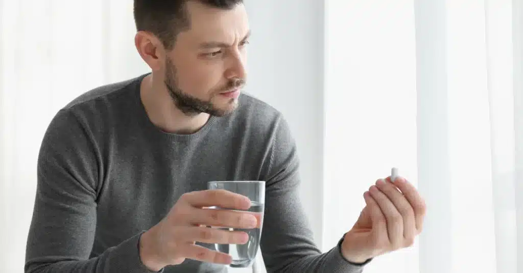 A man holding a tablet of viagra