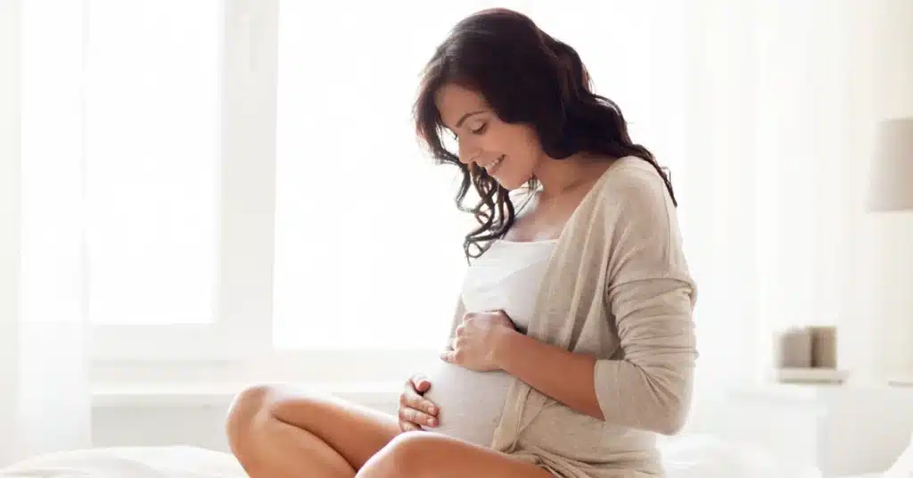 A pregnant woman rubbing her belly