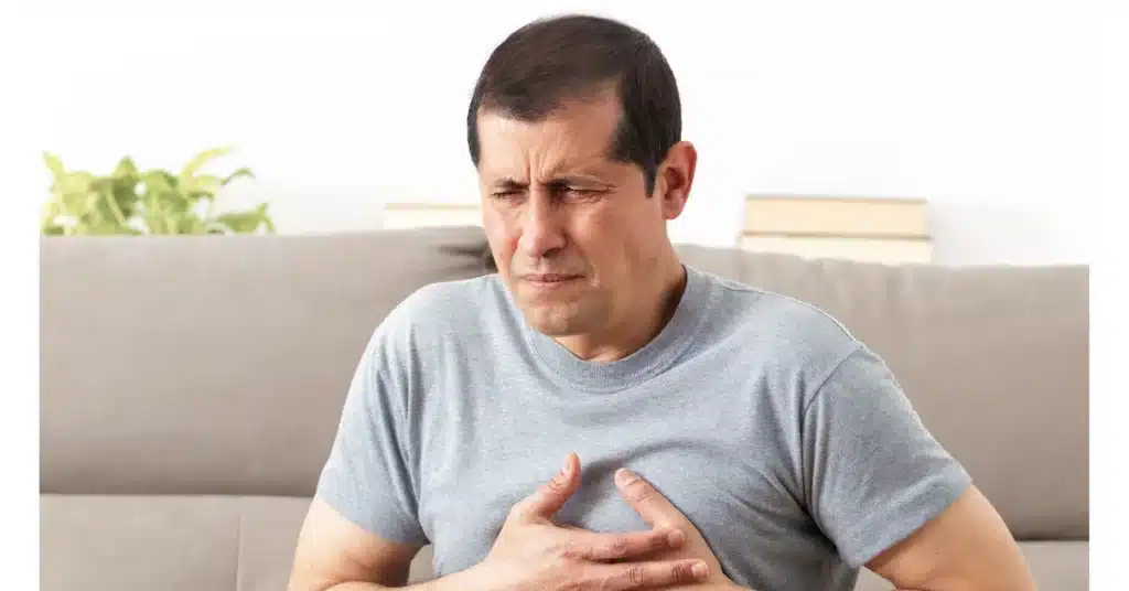 man holding his chest in pain