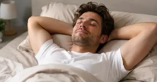 Relaxed man resting in bed