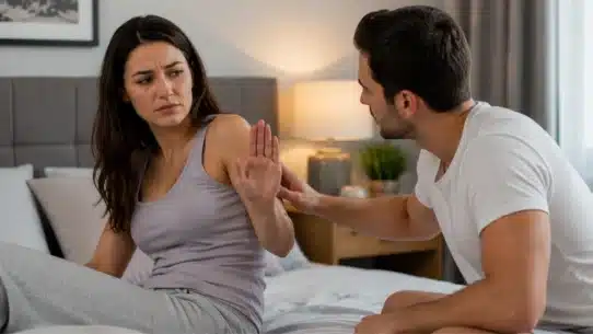 Woman avoiding intimacy while partner discusses sexual arousal concerns