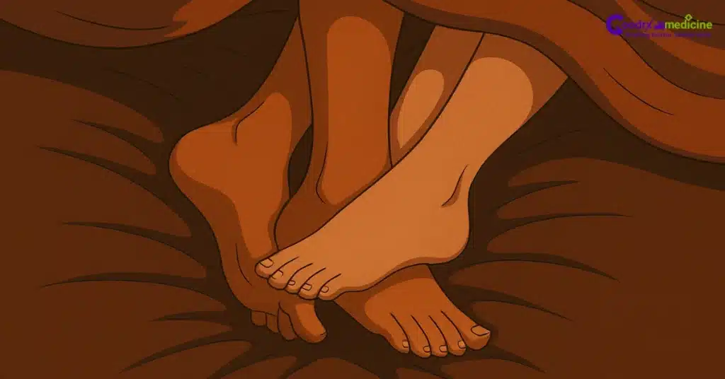 Couple's feet intertwined on cozy bed