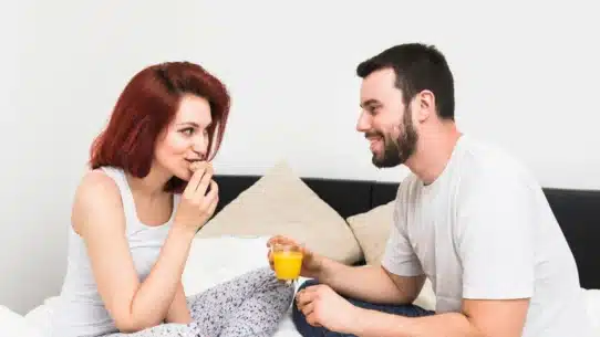 Couple eating on bed