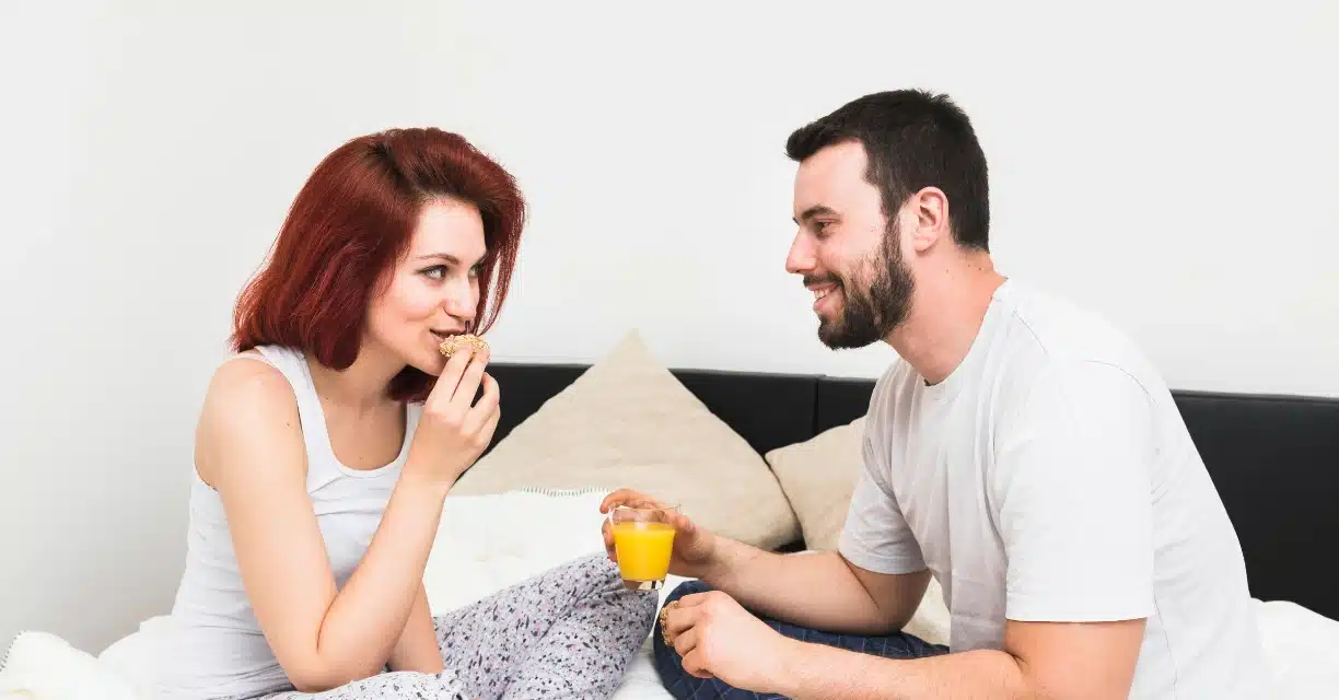 Couple eating on bed