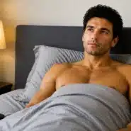 Man lying awake in bed