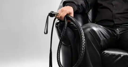 Person holding whip representing sexual sadism disorder symptoms